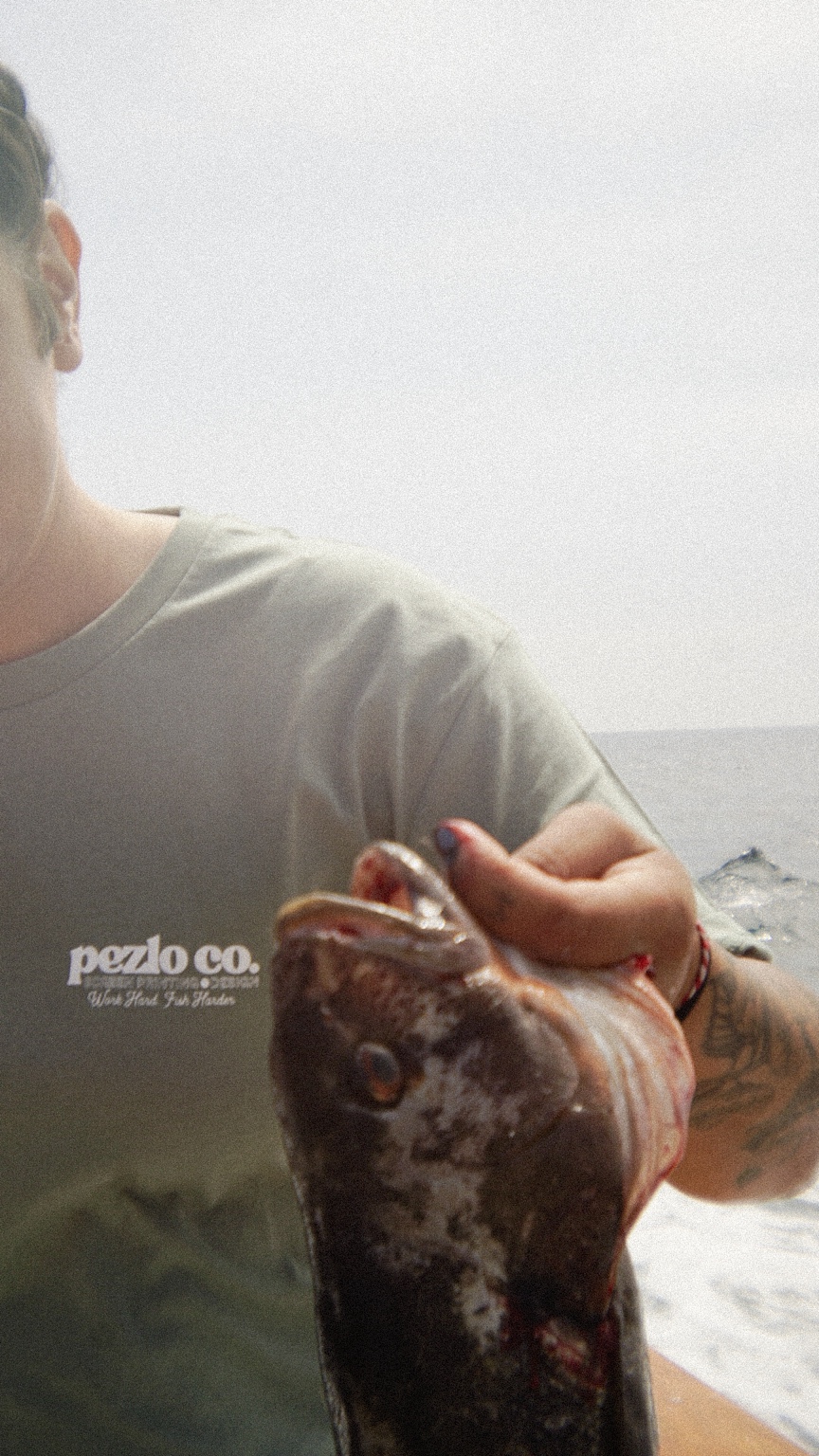 Pezlo Co. shirt worn while holding a freshly caught fish